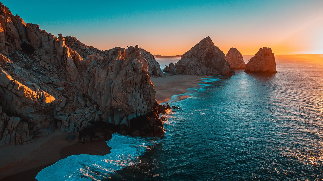 Granite sea stacks and a hidden beach at sunset in Los Cabos